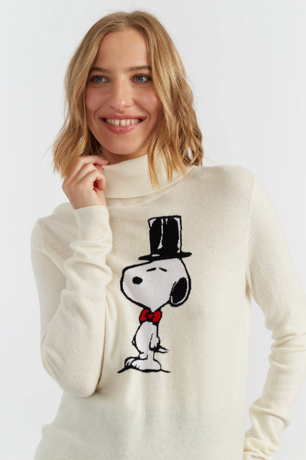 Woman wearing a cream sweater with a cartoon character design on a white background