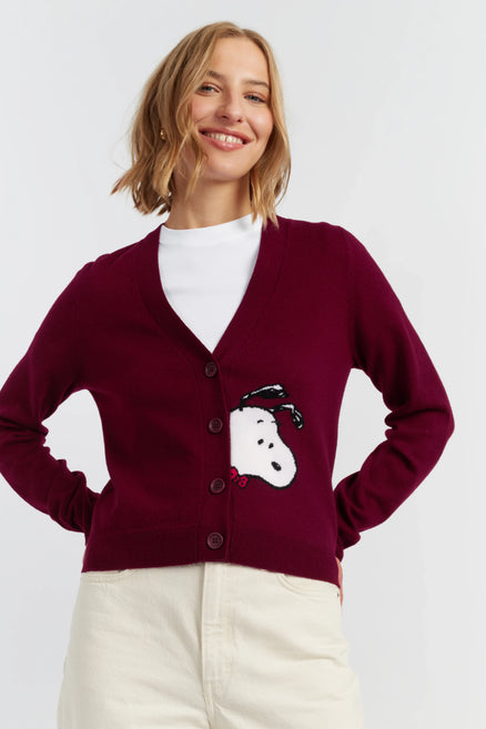 Woman wearing a burgundy cardigan with a snowman design on a white background